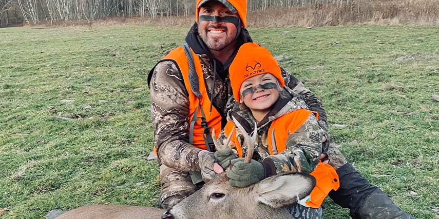 Natie Hosie with his son Cruze and his First Buck!