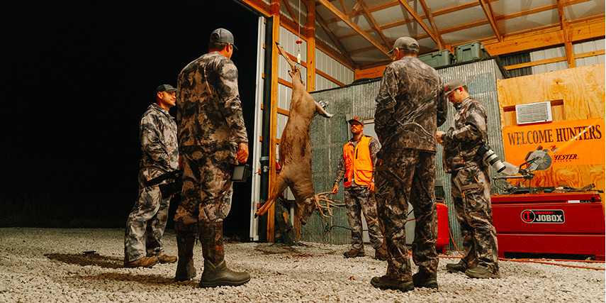 Hunters Standing around their Deer chatting